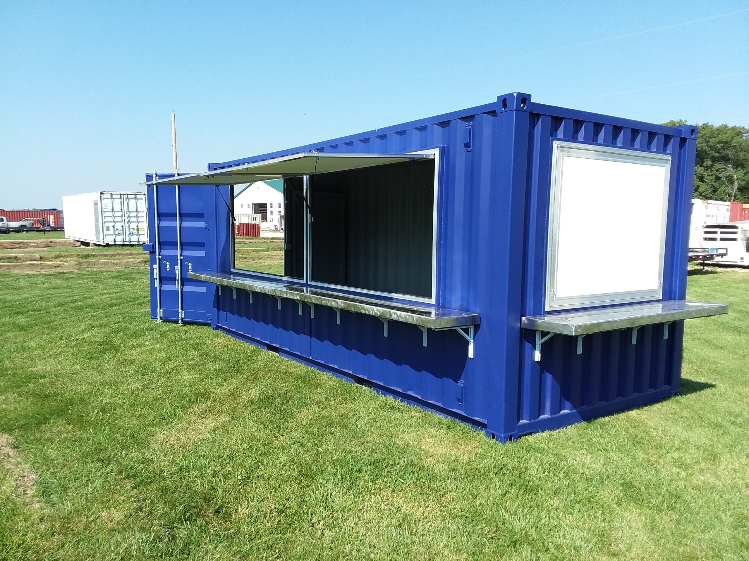 A bright blue concession stand made from a custom shipping container