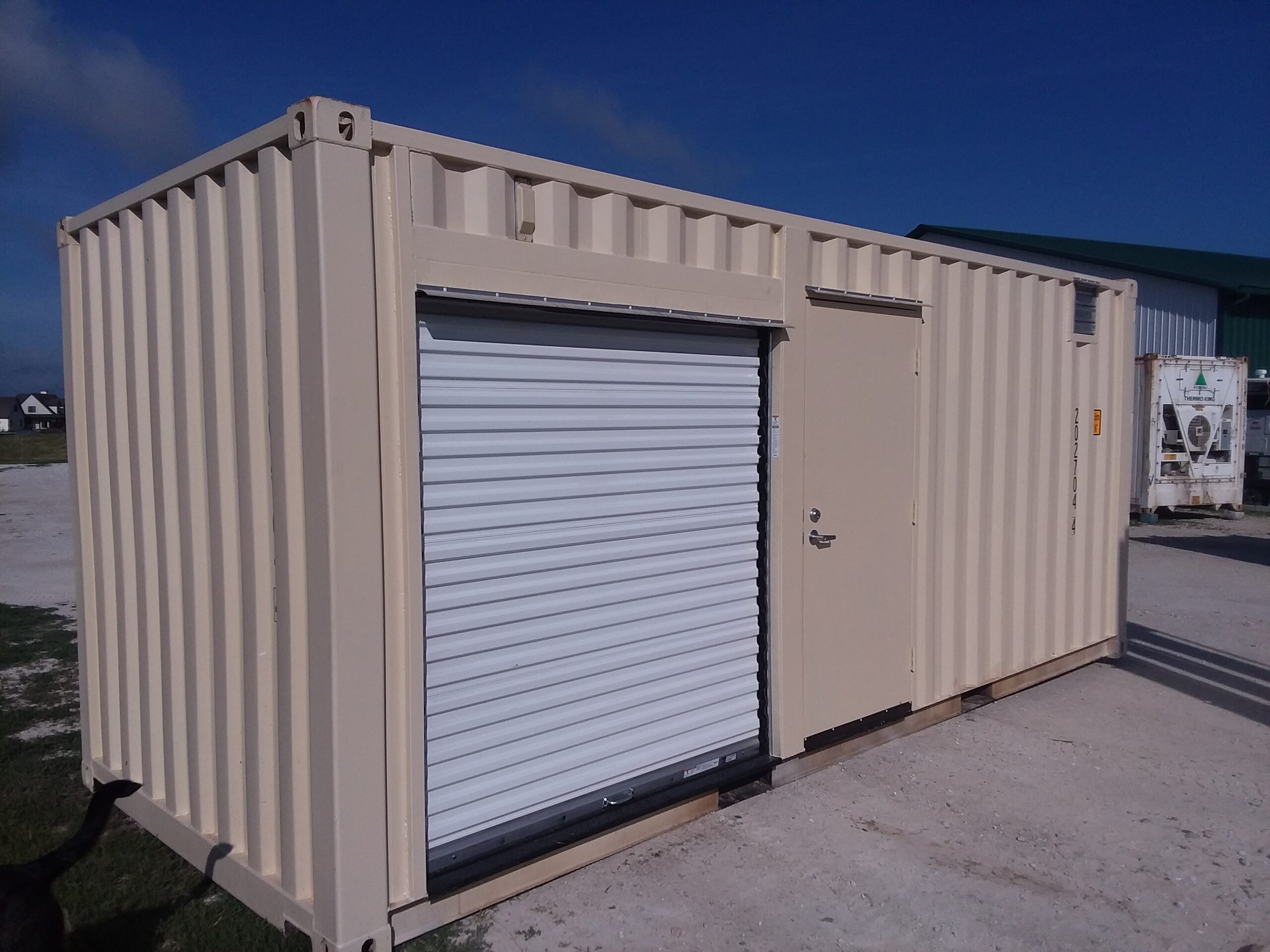 One of USA-Containers Custom Shipping Containers in Iowa. Brown. Door Ajar.